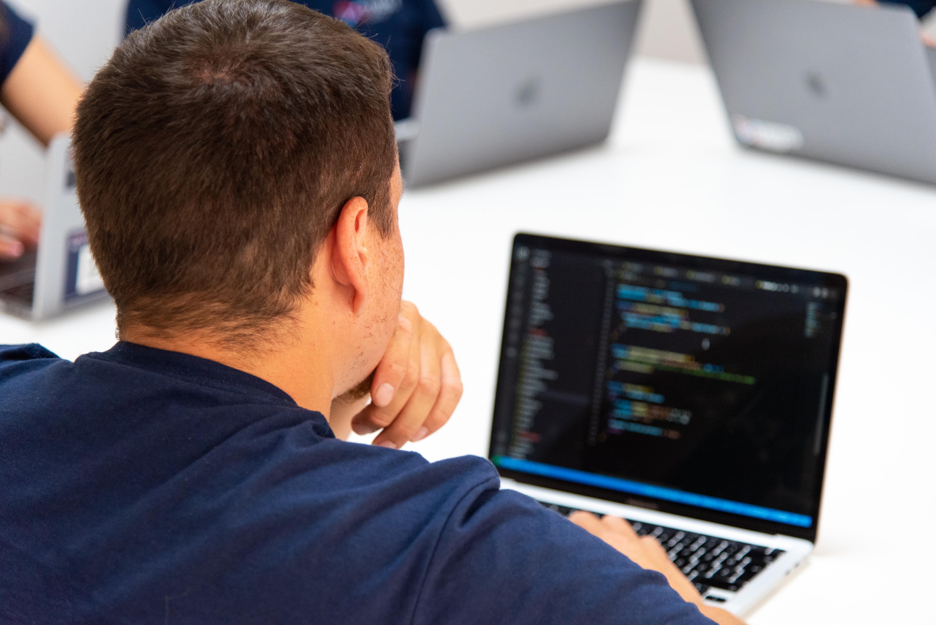 A Tilde Loop engineer pair-programming at a workstation